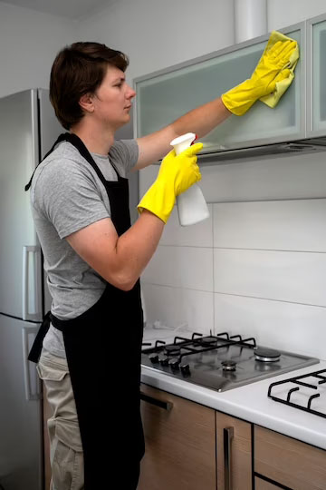 Professional Home Cleaning Services employee cleaning kitchen